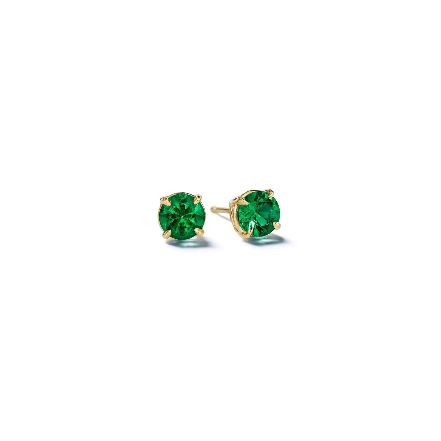 A pair of round brilliant cut emerald stud earrings in 18-karat gold on a white background