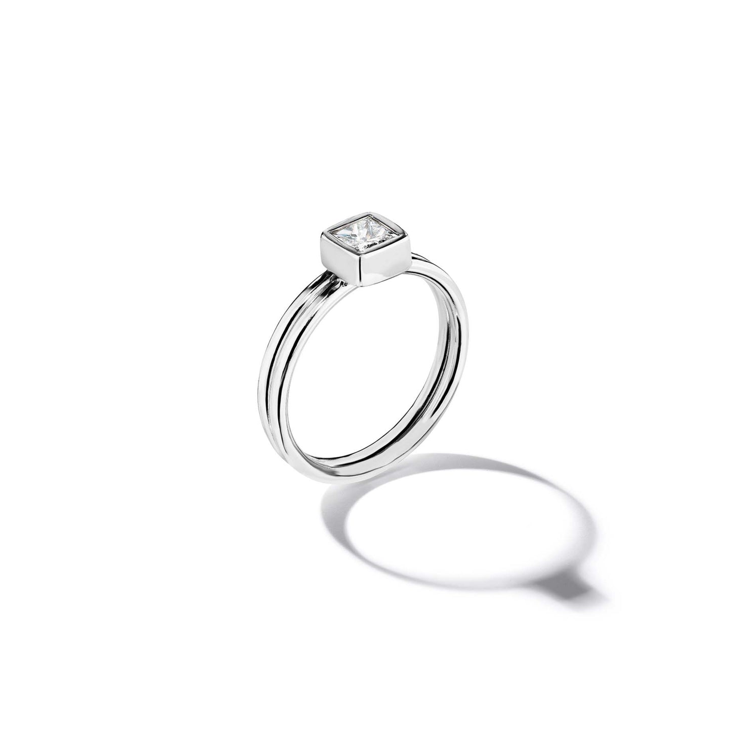 18k white gold ring with a diamond on a white background