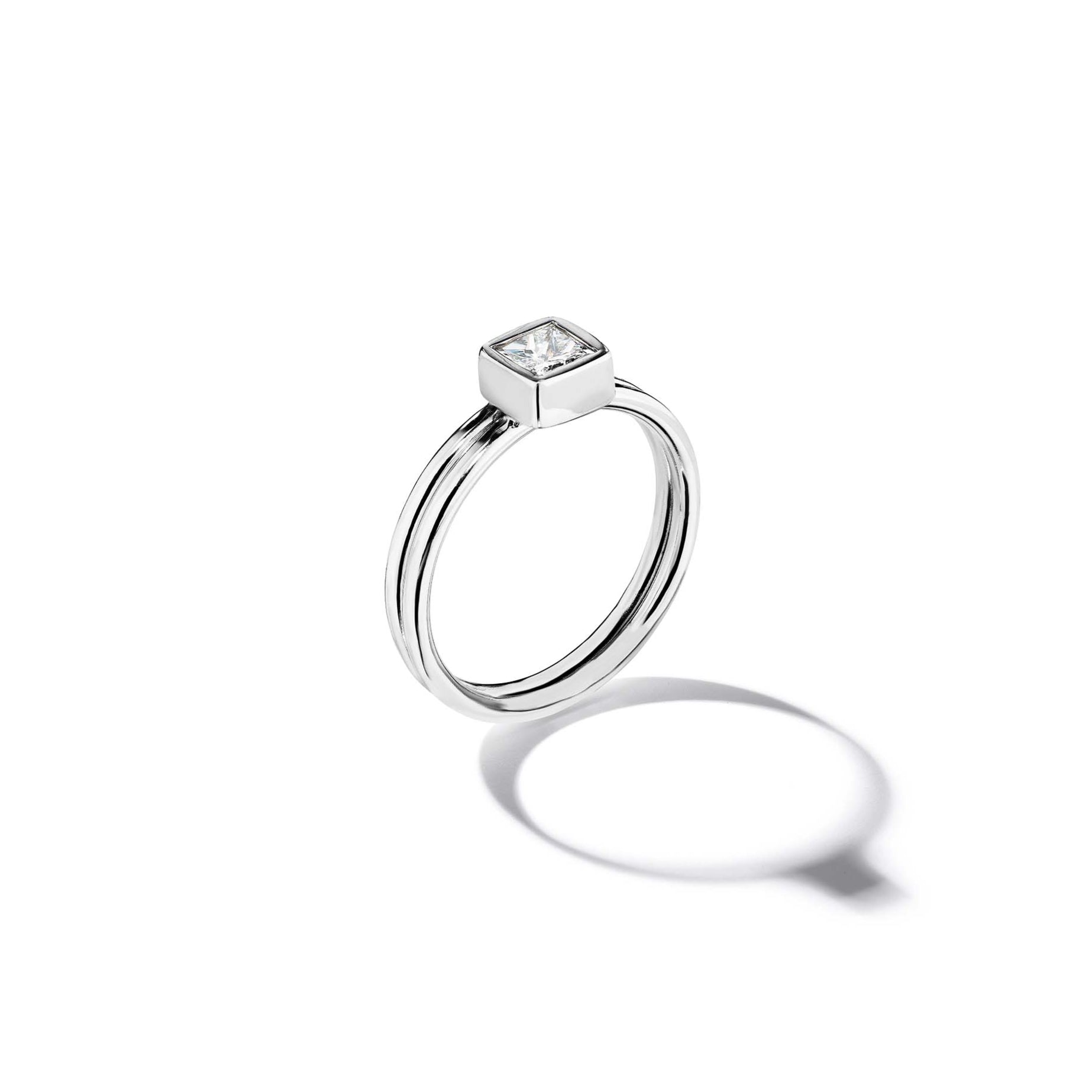 18k white gold ring with a diamond on a white background
