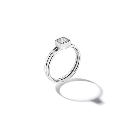 18k white gold ring with a diamond on a white background
